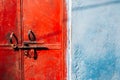 Old rusty red metal door and blue wall Royalty Free Stock Photo