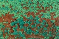 Rusty red metal wall weth peeling flakes of lime green paint tex Royalty Free Stock Photo