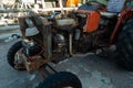 Rusty red tractor with the engine uncovered close up