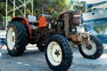 Rusty red tractor with the engine uncovered