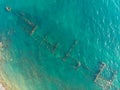 The rusty remains of the old sea dry cargo ship on the shallow water