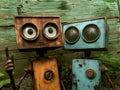 Whimsical rusty robots posing in front of wooden background
