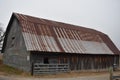 Rusty rotting old barn with open gate in Washita Arkansas