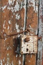 Rusty rural handmade lock on aged wooden shed door