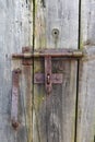 Rusty rural handmade lock on aged wooden village barn door