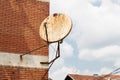 Rusty satellite dish on the outside wall Royalty Free Stock Photo