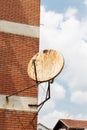 Rusty satellite dish on the outside wall Royalty Free Stock Photo