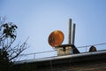 Rusty satellite dish on the roof of the house