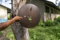 Rusty School Bell For Signalize about a School Brake Hanging on the Tree Near African school building in Primary School