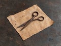 Rusty scissors on old paper