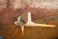 Rusty screw, a shaft and the underwater part of a hull of a ship that dry docked