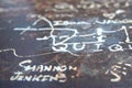 Rusty sheet metal scratched with text, selective focus Royalty Free Stock Photo