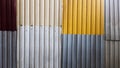 Rusty sheets of corrugated iron in different colors. Texture background of brown, gray, yellow, green corrugated fence. Colorful Royalty Free Stock Photo