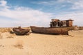 rusty ship at the bottom of the former Aral Sea. The dried-up sea in an environmental disaster and climate change in Royalty Free Stock Photo