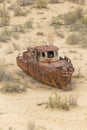Rusty ship at the ship cemetery in former Aral sea port town Moynaq Mo ynoq or Muynak , Uzbekist Royalty Free Stock Photo