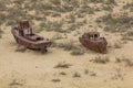 Rusty ships at the ship cemetery in former Aral sea port town Moynaq Mo ynoq or Muynak , Uzbekist Royalty Free Stock Photo