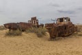 Rusty ships at the ship cemetery in former Aral sea port town Moynaq Mo ynoq or Muynak , Uzbekist Royalty Free Stock Photo