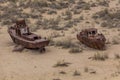 Rusty ships at the ship graveyard in former Aral sea port town Moynaq Mo ynoq or Muynak , Uzbekist Royalty Free Stock Photo