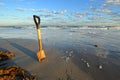 Rusty Shovel in Wet Sand at the Beach