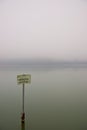 Rusty sign in a lake indicating that it is a nature reserve