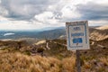 Rusty sign of viewpoint in Gold`s Road, San Luis, Argentina, which climbs steppe mountains with curved ascending ways