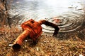 A rusty silencer, thrown to drown in a pond. Royalty Free Stock Photo