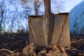 Rusty spade stuck to the ground against blue sky Royalty Free Stock Photo