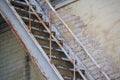 Rusty staircase at an old wall