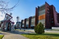 Rusty steel building of European Solidarity Center and museum in Gdansk and the monument to the Fallen Shipyard Workers of 1970 wi Royalty Free Stock Photo