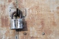 Rusty steel doors locked with padlock