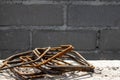 Rusty steel rebar scraps. Stack of rust.y iron rods or bars on the background of a concrete wall Royalty Free Stock Photo