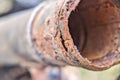 Rusty steel tube with holes of metallic corrosion. Royalty Free Stock Photo