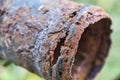 Rusty steel tube with holes of metallic corrosion. Royalty Free Stock Photo