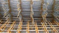 Rusty steel welded wire mesh background. Reinforcing frame of the base plate. Building materials warehouse for construction of fou