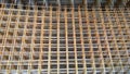 Rusty steel welded wire mesh background. Reinforcing frame of the base plate. Building materials warehouse for construction of fou