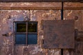 Rusty steel window on very old wooden door on prison Royalty Free Stock Photo