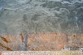 Rusty step visible through shallow transparent river water Royalty Free Stock Photo