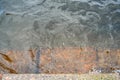 Rusty step visible through shallow transparent river water Royalty Free Stock Photo