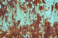 Rusty surface of metal plate with blue cracked color paint. Rust on old colored metal. Old blue fence. Grunge ruststained metal Royalty Free Stock Photo