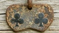 Rustic Rusty Metal Plaque with Two Black Clover Symbols on Wood Royalty Free Stock Photo