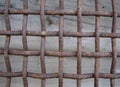 Rusty thick heavy intertwined metal vintage grid surface on wood