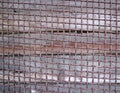 Rusty thick intertwined metal vintage grid on wood backgrnd