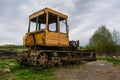 Rusty tractor on tracks in the field Royalty Free Stock Photo
