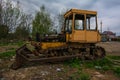 Rusty tractor on tracks in the field Royalty Free Stock Photo