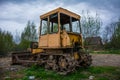 Rusty tractor on tracks in the field Royalty Free Stock Photo