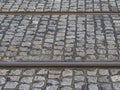 Rusty tram rail line track with gray cobble stone in prague