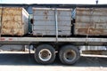 Rusty trash dumpsters on flatbed trailer