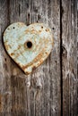 Rusty trim on keyhole as heart on old wooden door. Vertical shot Royalty Free Stock Photo