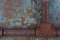 Rusty valve pipes on rusty metal wall Royalty Free Stock Photo