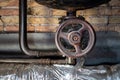 Rusty valves on boiler room pipes. Old metal boiler generating heating and delivering it to home through pipeline Royalty Free Stock Photo